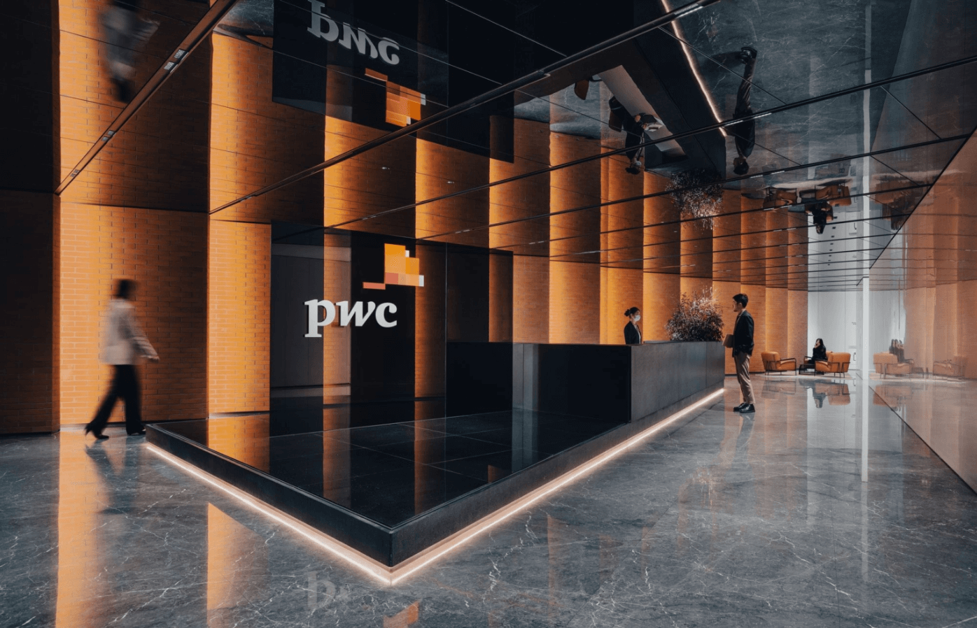 PwC Shanghai lobby with warm amber lighting and marble floors